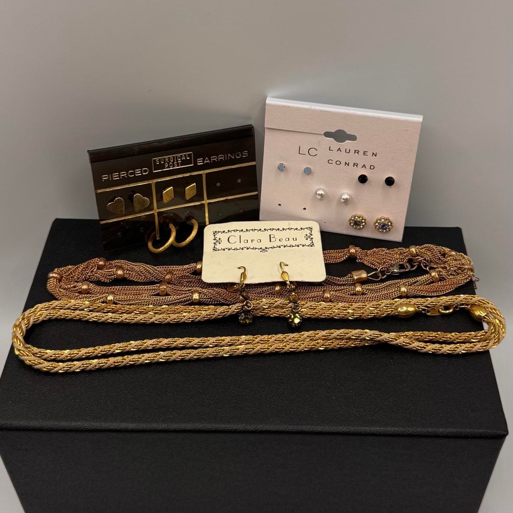 Multi piece jewelry bundle with gold chain necklace, earrings, and bracelets